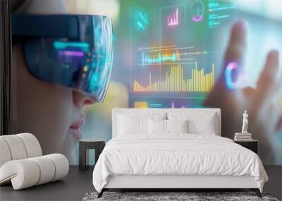 Close-up of woman`s face wearing AR glasses with hand in the air interacting with yellow blue and purple holographic data frame, showing various types of charts. Modern futuristic business solutions.  Wall mural